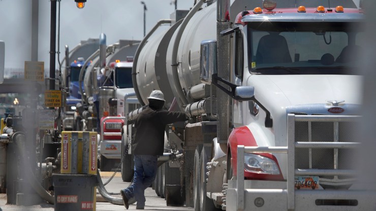 A driver empties his tanker truck of crude oil at Marathon Oil to be refined into gas on May 20, 2021 in Salt Lake City, Utah.