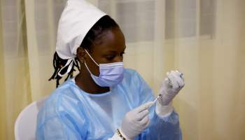 A medical worker prepares a dose of the AstraZeneca COVID vaccine in a vaccination center in Kigali, Rwanda.