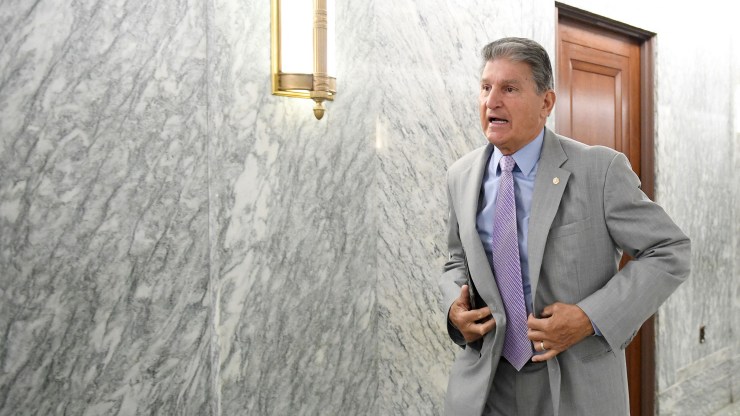 Sen. Joe Manchin, D-W.V., walks down a hallway on Capitol Hill.