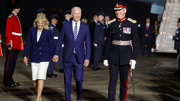 President Joe Biden (center) and first lady Jill Biden (left) react upon arrival at Cornwall Airport Newquay, on June 9, 2021 near Newquay, Cornwall, England.