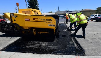 A crew works on resurfacing a road in Alhambra, California.