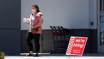 A customer walks by a "We're Hiring" sign outside a Target store on June 3, 2021 in Sausalito, California.