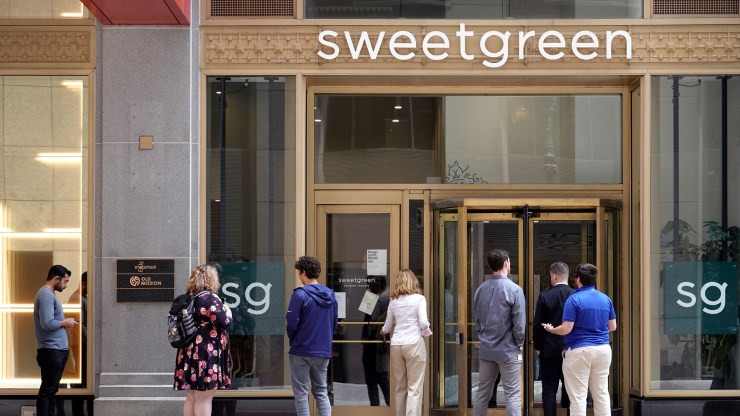 Customers wait in line to enter a Sweetgreen restaurant on June 21, 2021 in Chicago, Illinois.