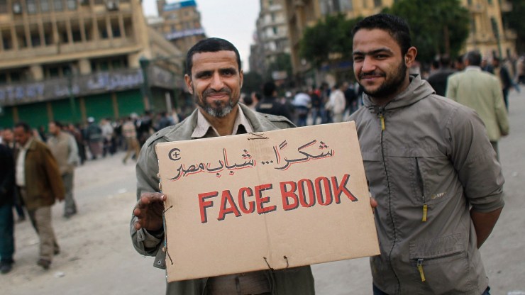 A protester in Egypt holds a sign labeled, "Facebook" as part of a protest against President Hosni Mubarak in 2011.