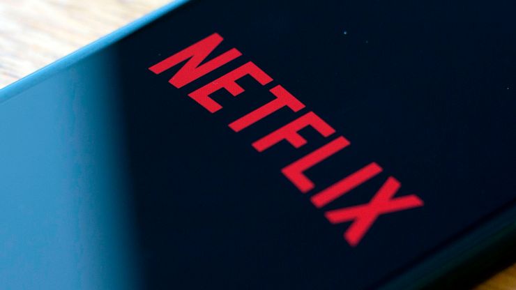 The Netflix logo is seen on a phone.