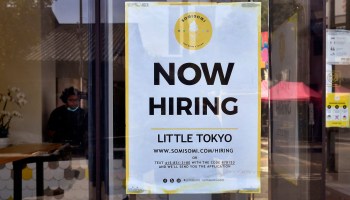 A Now Hiring sign is posted at an ice cream shop in Los Angeles.