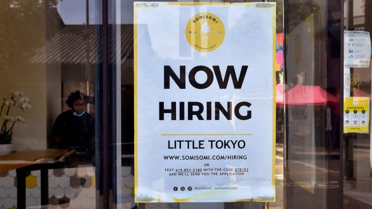 A Now Hiring sign is posted at an ice cream shop in Los Angeles.
