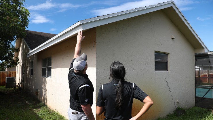 Zillow renovation estimators examine a home.