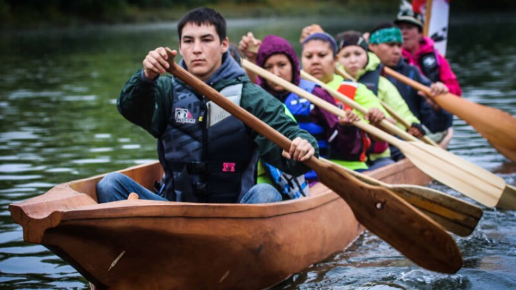 Nez Perce tribal members paddle on the Snake River in a canoe they carved as part of a culture and environmental learning project supported by the Potlatch Fund.