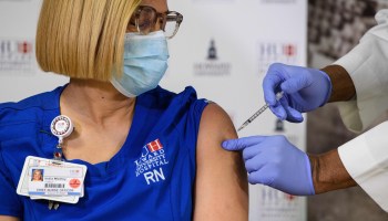 India Medley, chief nursing officer at Howard University Hospital, receives the COVID-19 vaccine in December. Many patients expect their doctors and nurses to be vaccinated.