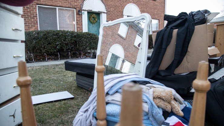 The belongings of an evicted apartment resident sit on a lawn outside of their Columbus, Ohio, apartment in March 2021.