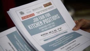 An employer holds flyers for hospitality employment during a Zislis Group job fair at The Brew Hall on June 23, 2021 in Torrance, California.