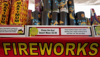 Fireworks for sale on a shelf.