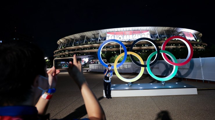 People take a photo of Olympic Rings outside the stadium during the Opening Ceremony of the Tokyo 2020 Olympic Games at Olympic Stadium on July 23, 2021 in Tokyo, Japan.