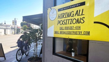 A "Hiring All Positions" sign is displayed at a pastry shop on June 23, 2021 in Los Angeles, California.