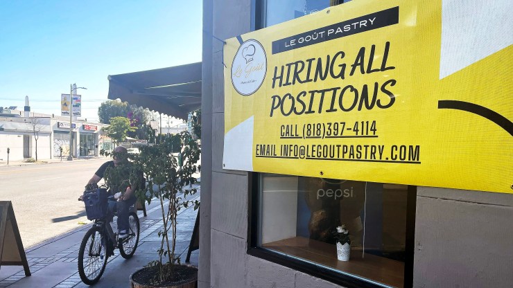 A "Hiring All Positions" sign is displayed at a pastry shop on June 23, 2021 in Los Angeles, California.
