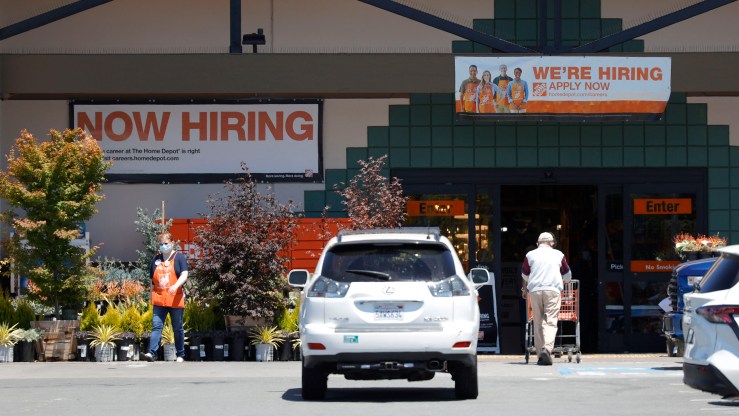 "Now Hiring" signs are posted in front of a Home Depot store on July 7, 2021 in San Rafael, California.