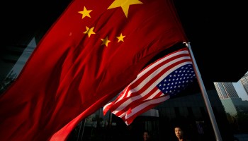 Chinese and US flags fly outside a hotel during a US presidential election results event organised by the US embassy in Beijing on November 7, 2012.