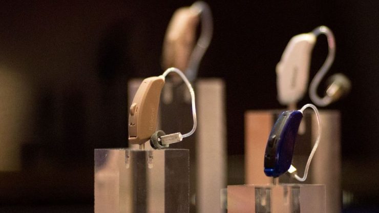 A collection of hearing aids are shown on display.