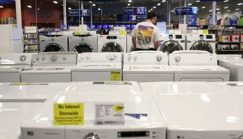 A Best Buy customer views a display of washing machines.