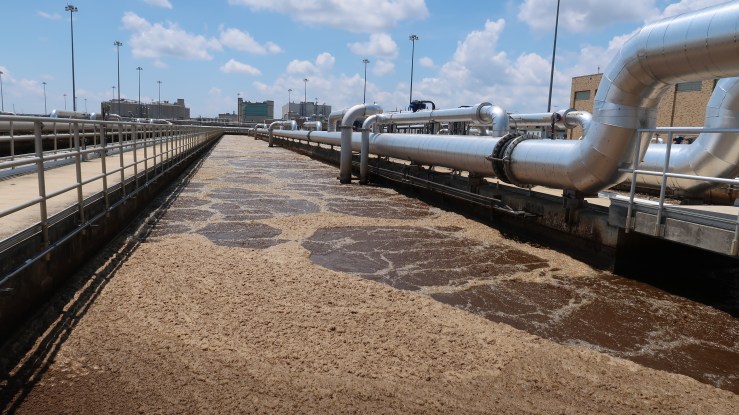 Brown, bubbly wastewater flows at the Blue Plains wastewater treatment facility.