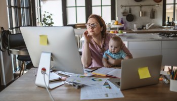 Mother with her baby boy working from home at time of isolation