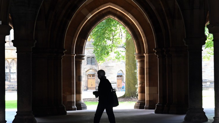 A student walks on the campus of University of Glasgow in Scotland on Sept. 24, 2020.