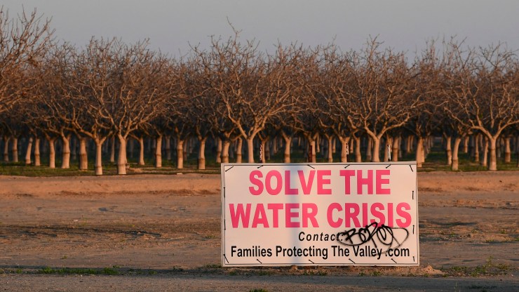 A sign calls for solving California's water crisis on the outskirts of Buttonwillow in California's Kern County on April 2, 2021, one of the top agriculture producing counties in the San Joaquin Valley where dairy, grapes, almonds, strawberries, and pistachios contribute billions to the economy each year.