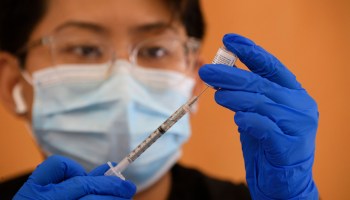 A health care worker prepares a dose of the Pfizer Covid-19 vaccine after it was approved for use by the FDA in children 12 and over at a Los Angeles County mobile vaccination clinic on May 14, 2021 in Los Angeles, California.