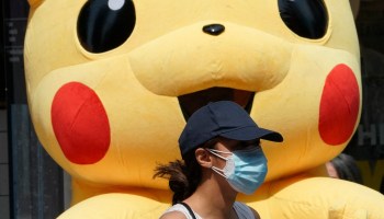 A person walks past a Pikachu mascot at Times Square on July 22, 2021.