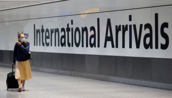 Travelers arrive at Heathrow's Terminal 5 in west London on August 2, 2021 as quarantine restrictions ease
