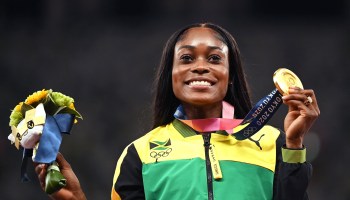 Gold medalist Jamaica's Elaine Thompson-Herah celebrates during the medal ceremony for the women's 200m event during the Tokyo 2020 Olympic Games at the Olympic Stadium in Tokyo on August 4, 2021.