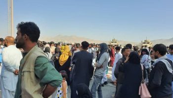Afghans crowd at the tarmac of the Kabul airport on August 16, 2021, to flee the country as the Taliban were in control of Afghanistan after President Ashraf Ghani fled the country and conceded the insurgents had won the 20-year war.