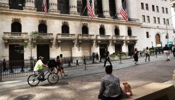 People walk outside of the New York Stock Exchange (NYSE) on August 26, 2016 in New York City.