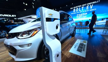 A Chevy Bolt electric vehicle on display at an auto show.