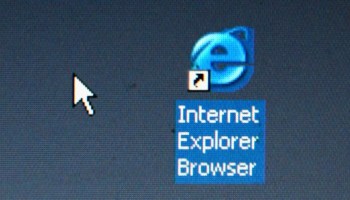 On a computer screen, the internet explorer blue 'E' logo is highlighted with the text "Internet Explorer Browser" with a white computer mouse to the left of it,
