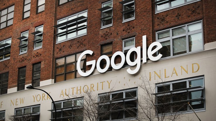A white 'Google' sign hands outside of the New York headquarters.
