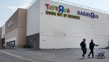 The exterior of a Toys R Us store with a "Going out of business" sign posted.