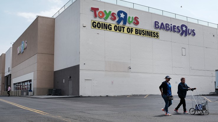 The exterior of a Toys R Us store with a "Going out of business" sign posted.