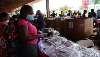 Alexis Whitley examines donated, individually wrapped school uniforms at the Get Ready 4 School Giveaway.