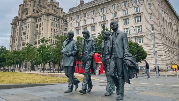 A Beatles statue in Liverpool is shown.