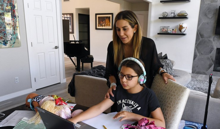 Amy Conrad helps her daughter Luca Conrad, 10, a Goolsby Elementary School fourth grader, take an online class at their home during the first week of distance learning for the Clark County School District back in August 2020.