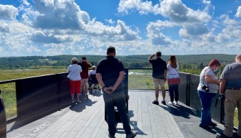 Visitors look out over the crash site at the Flight 93 National Memorial in Shanksville, Pennsylvania on September 9, 2021.