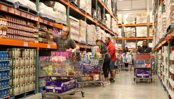 Shoppers walk the aisles of a Costco. Bulk buying can help your budget if you can afford the upfront costs, though it can also depend on the item and the size of your household.