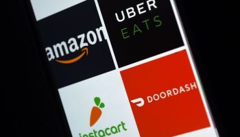 This illustration picture shows delivery applications logos from Amazon, Uber Eats, Instacart and Doordash displayed on a smartphone on April 10, 2020, in Arlington, Virginia - More and more people use the delivery apps as they are sheltering at home,avoiding going out as much as possible due to the coronavirus outbreak. (Photo by Olivier DOULIERY / AFP) (Photo by OLIVIER DOULIERY/AFP via Getty Images)