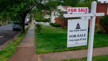 A For Sale sign near houses in Arlington, Virginia.