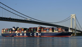 A container vessel passes under the Verrazzano-Narrows Bridge in New York. Although import prices eased in August, they were up 9% year over year.