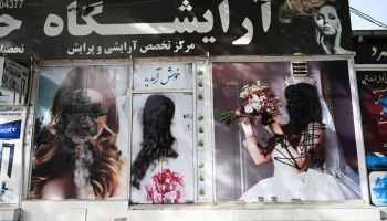 The facade of a beauty salon is pictured with images of women defaced using spray paint in Shar-e-Naw in Kabul on Aug. 18, 2021.
