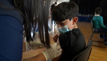 A boy receives the first dose of the Pfizer/BioNTech COVID-19 vaccine at a private school in Quito on September 13, 2021.