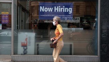 A "now hiring" sign in a store window in Manhattan in August.